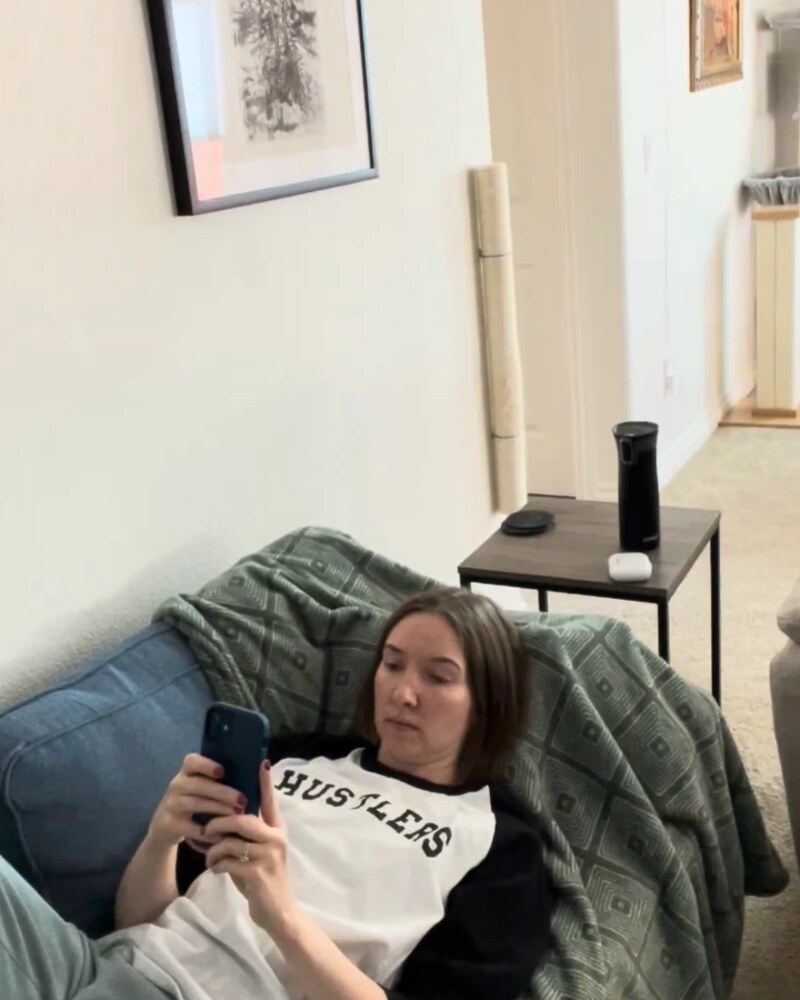 Jamie relaxing on the sofa with her phone