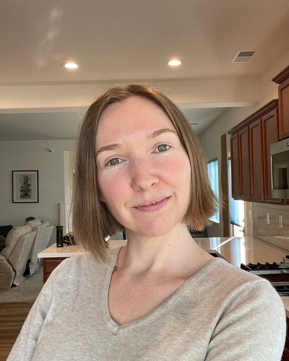 Jamie smiling in her kitchen